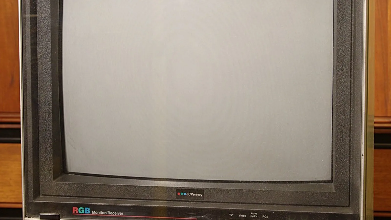 An old cathode ray television set with a blank grey screen