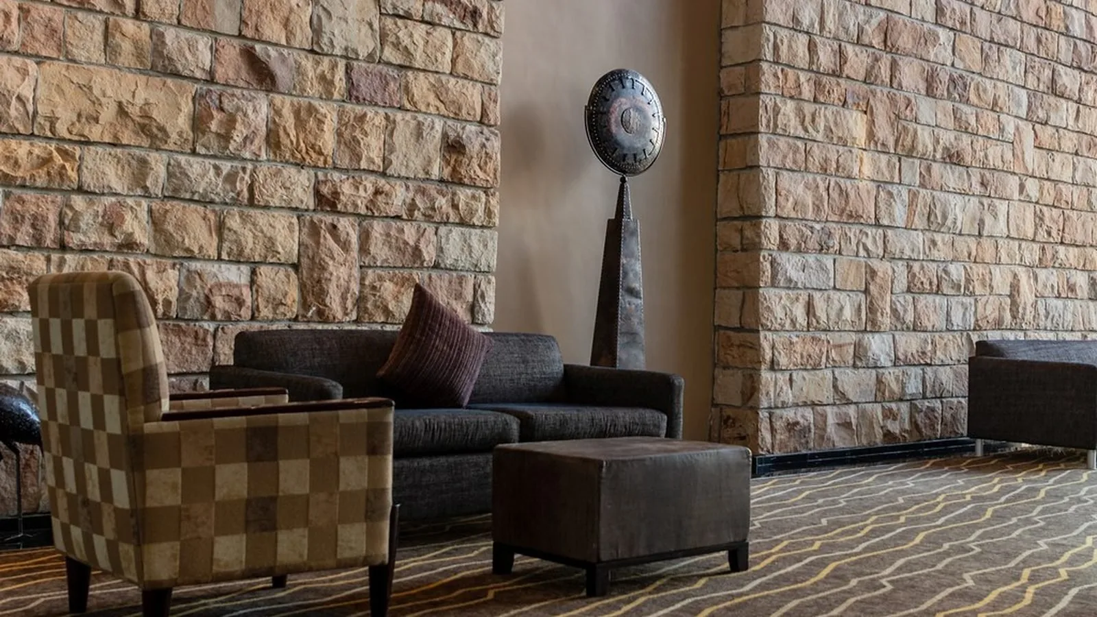 Armchairs and a low table in an empty lobby seating area